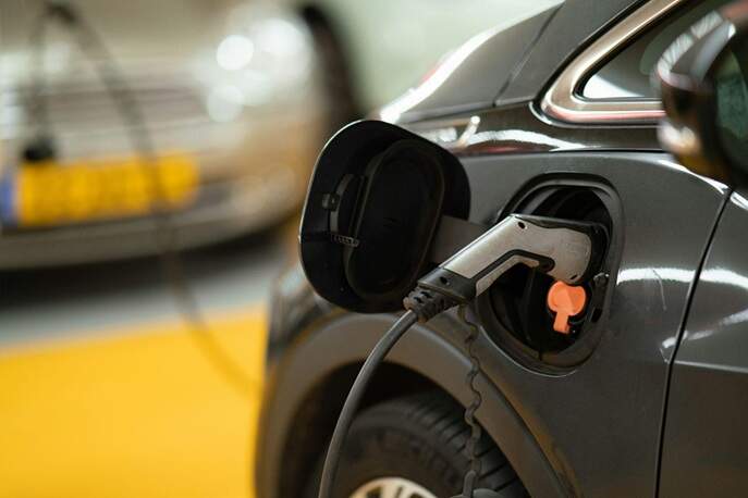 Charging Electric Vehicle Close-up of a black electric vehicle charging