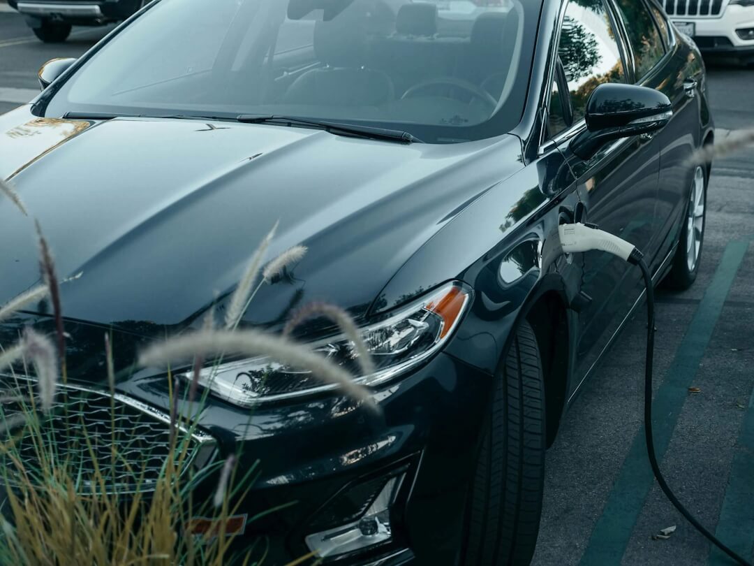 Hybrid car parked and charging at a public station