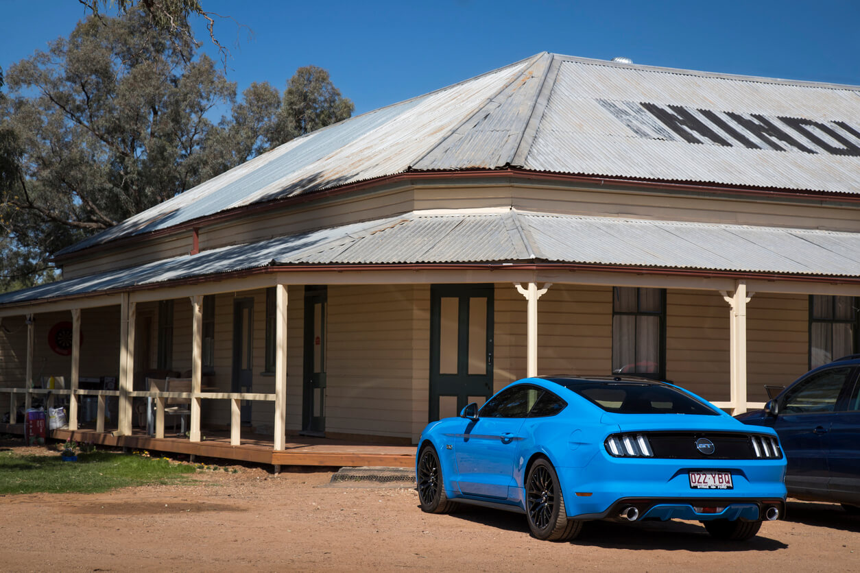 Blue ford mustang, parked outside an old homestead in Queensland