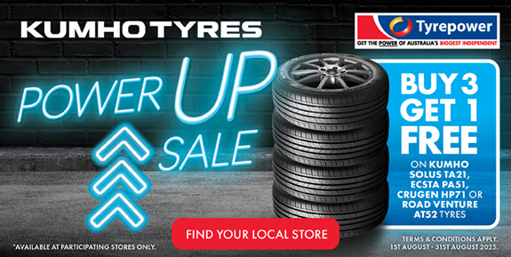 Stack of tyres with words 'Kumho Tyres Power Up Sale Buy 3 Get 1 Free'