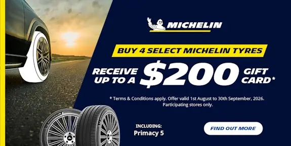 Promo for a $200 gift card offer, with a car on a highway and sunset in distance.