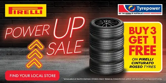 Promo image for a buy 3 get 1 free tyre sale with stack of tyres and neon text.