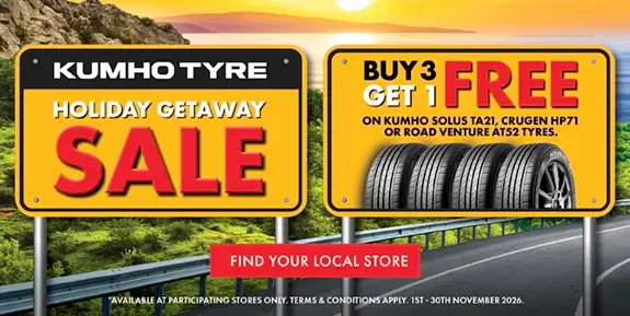Sign above highway saying Holiday Getaway Sale Buy 3 Get 1 Free